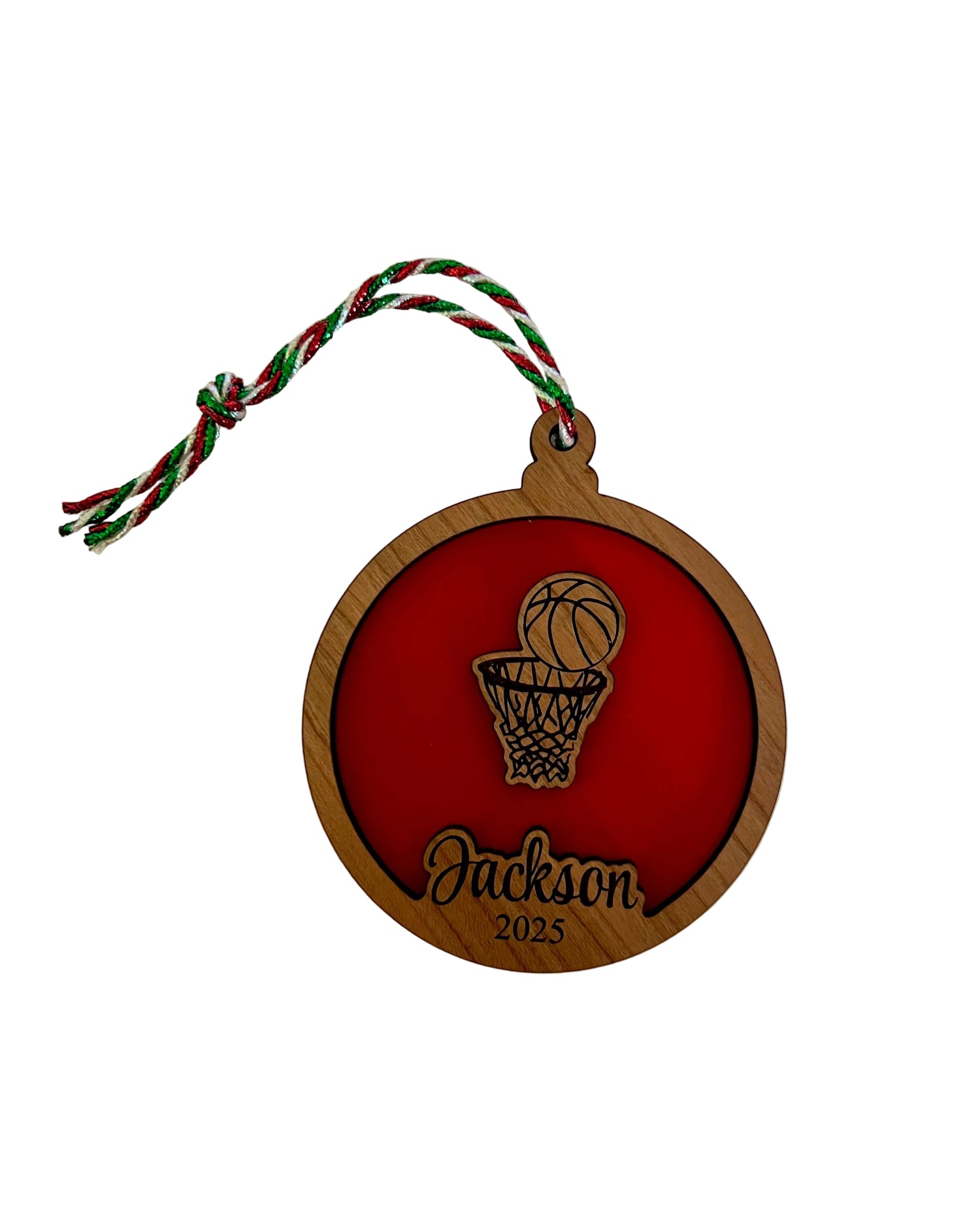 Personalized ornament with basketball design on a red background and 'Jackson, 2025' text engraved. 