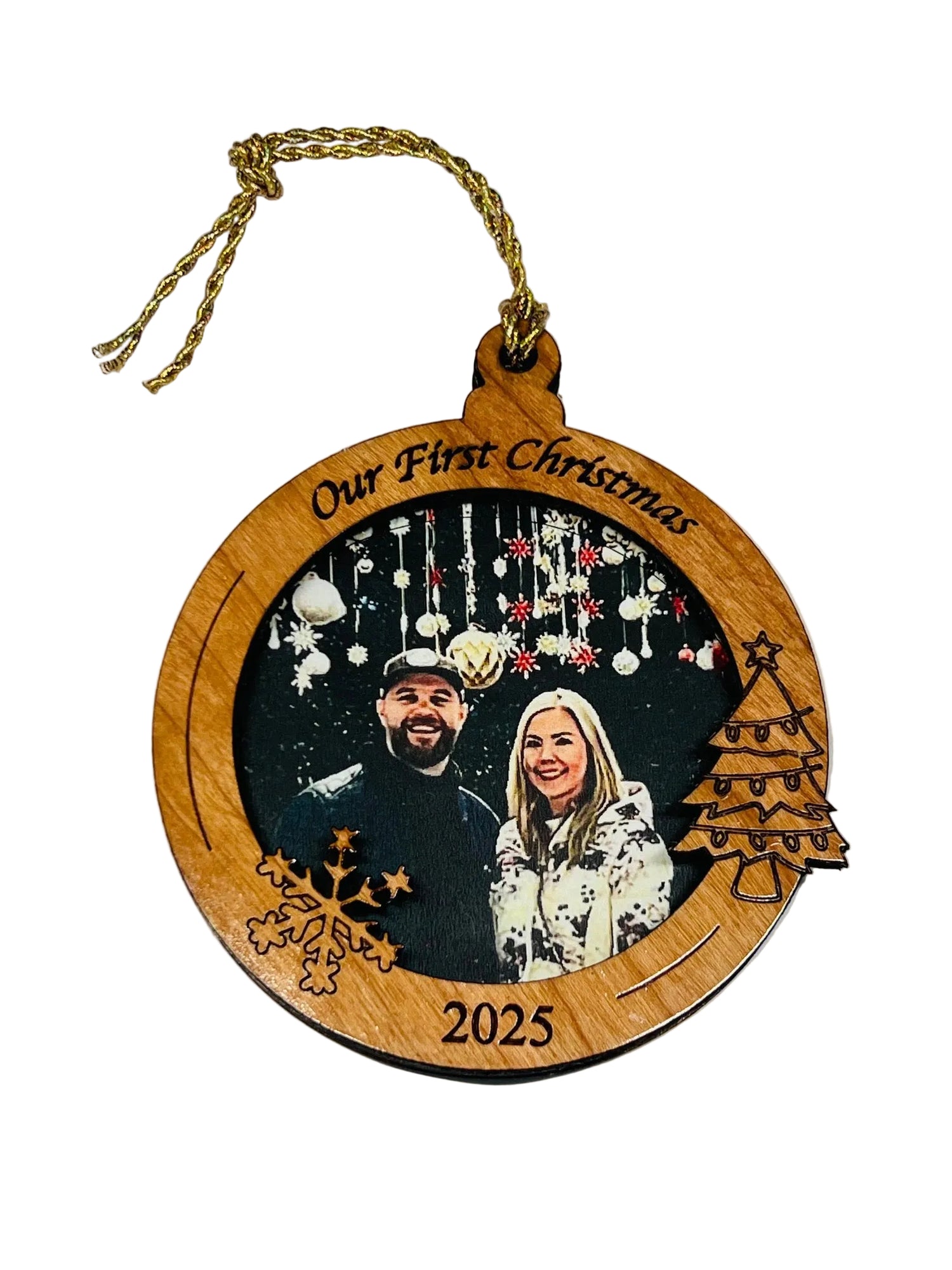 Wooden Christmas photo ornament with a photo of a couple and 'Our First Christmas, 2025' text engraved. 